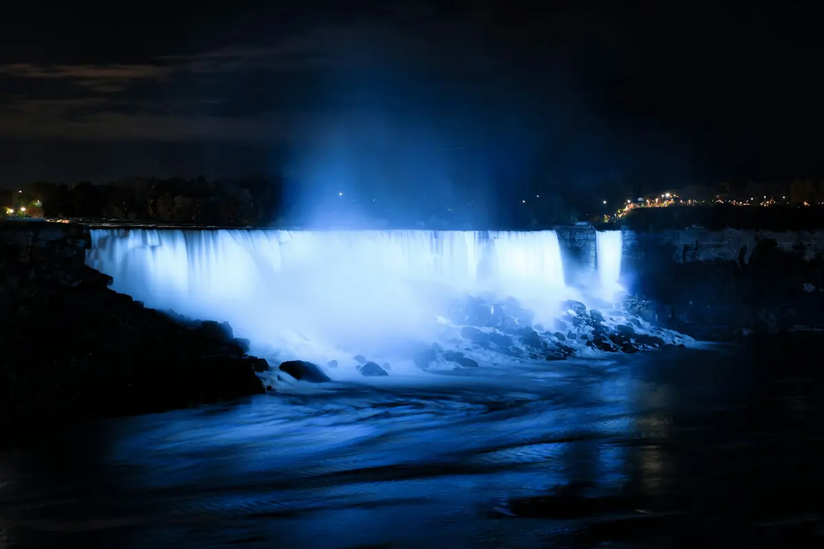 Niagara Falls lit up in blue at night
